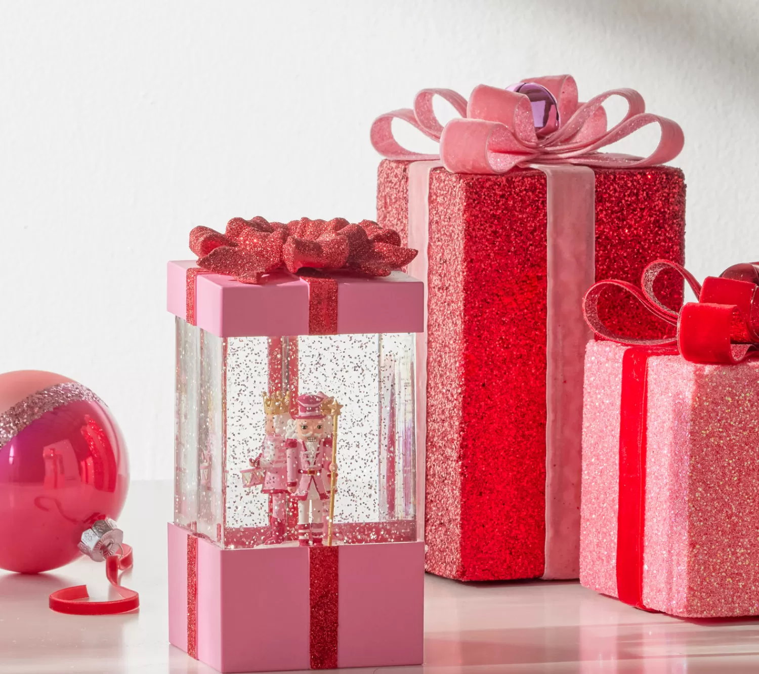 The Jolly Christmas Shop A Blushing Holiday | Pink Christmas Decorations | Raz 7.75" Blushing Pink Christmas Present Water Globe With Nutcracker 4400758